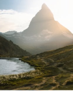 A lone peak above a lake at first light