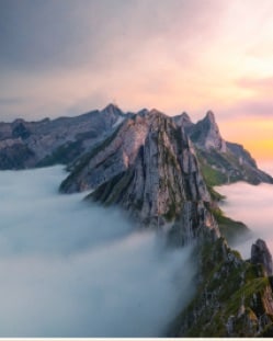 A rocky ridge rising out of a sea of cloud